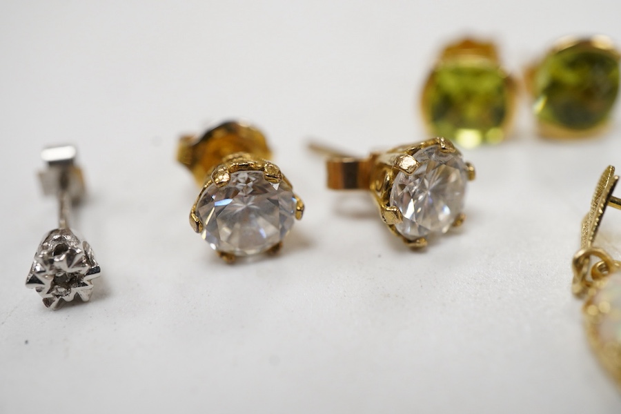 A pair of chequerboard cut peridot set 18ct stud earrings, a pair of amethyst set 9ct stud earrings and three costume pairs of earrings.
